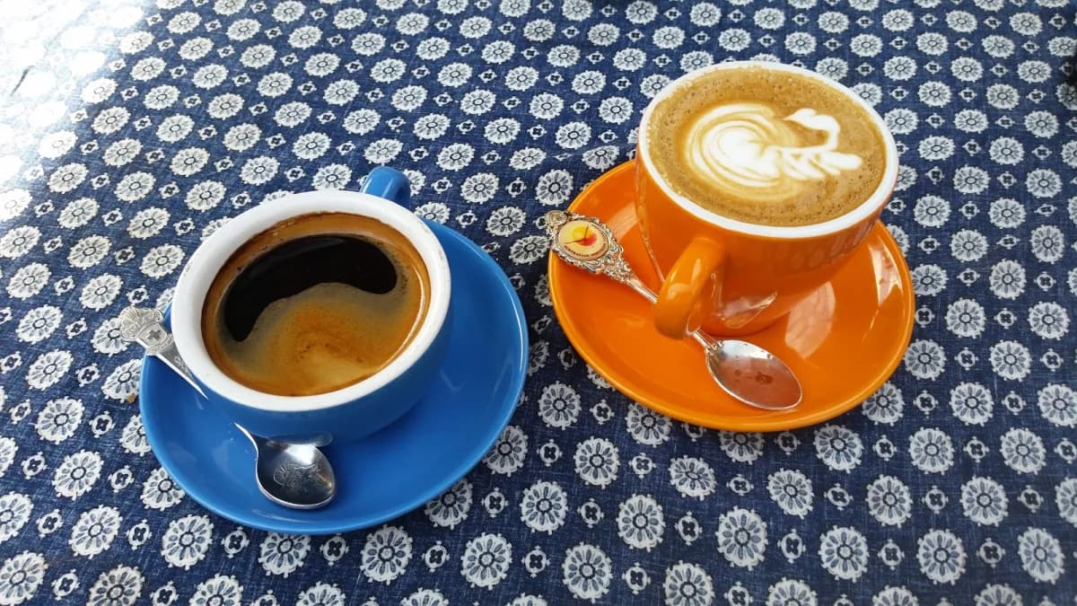 Latte art coffees on a decorative blue tablecloth