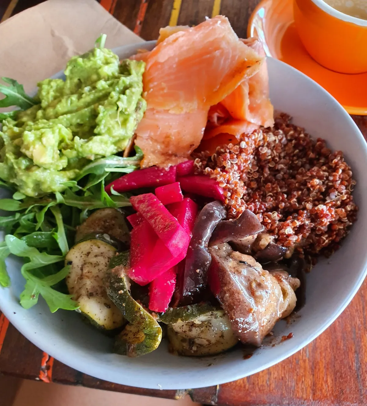 Tropical grain bowl with smoked salmon, avocado, and quinoa