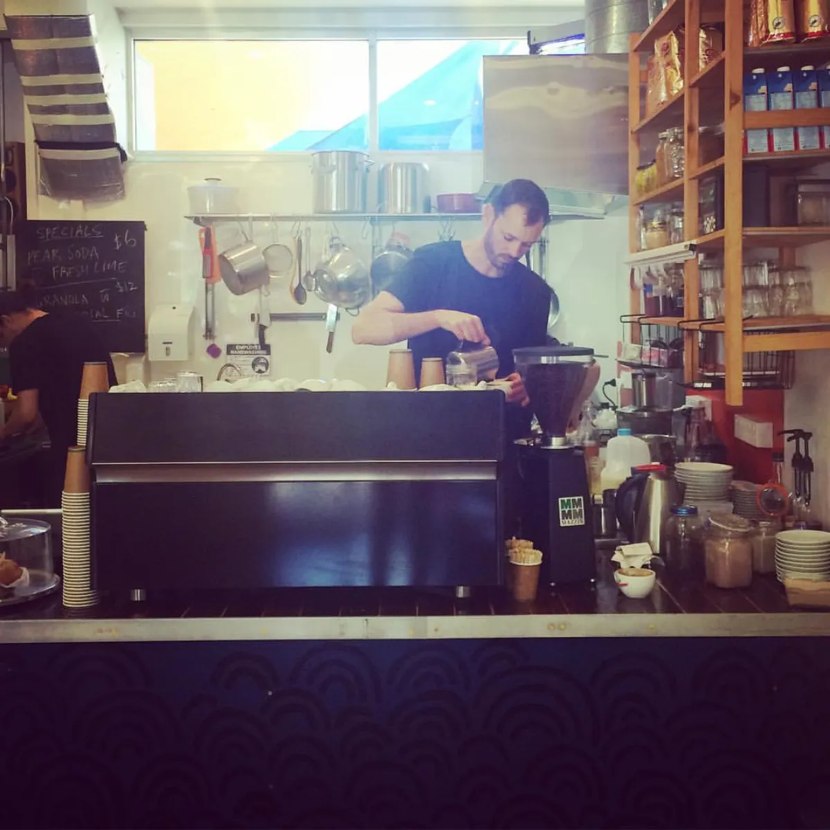 Lucky Bat barista working the espresso machine